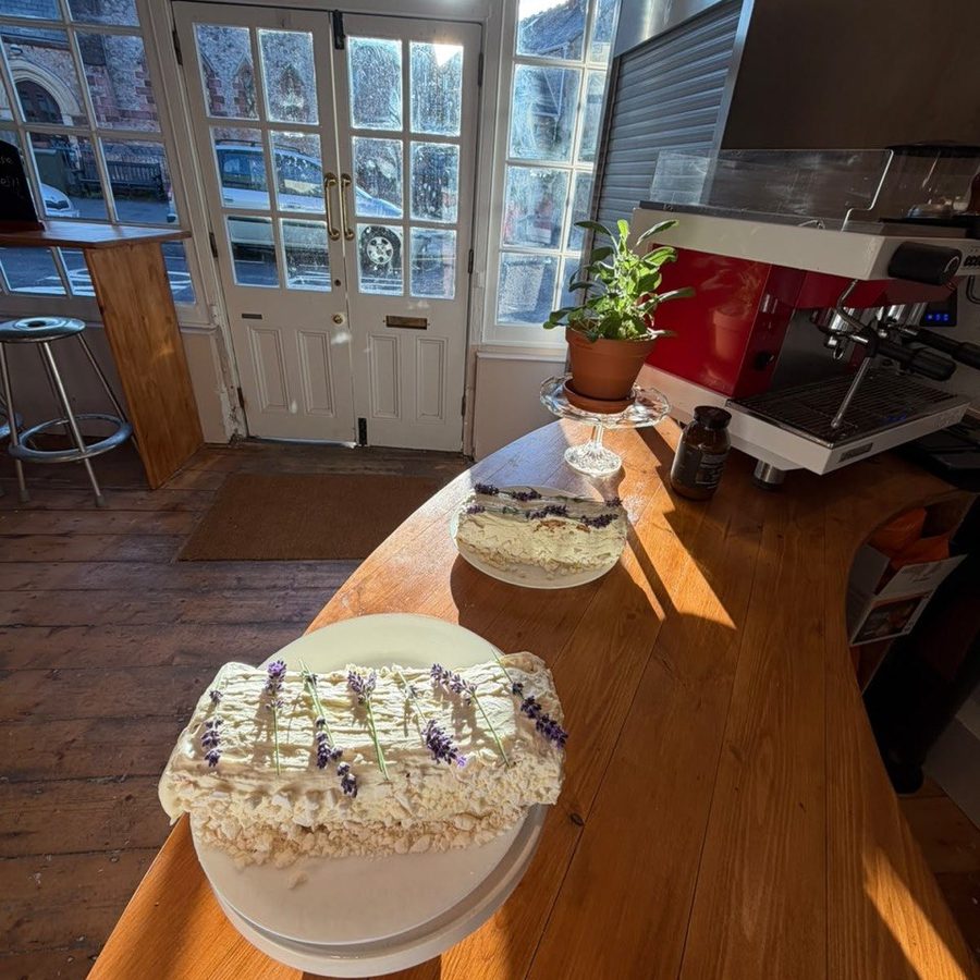 A lavender-topped cake on the counter, with the doors open onto Fore Street