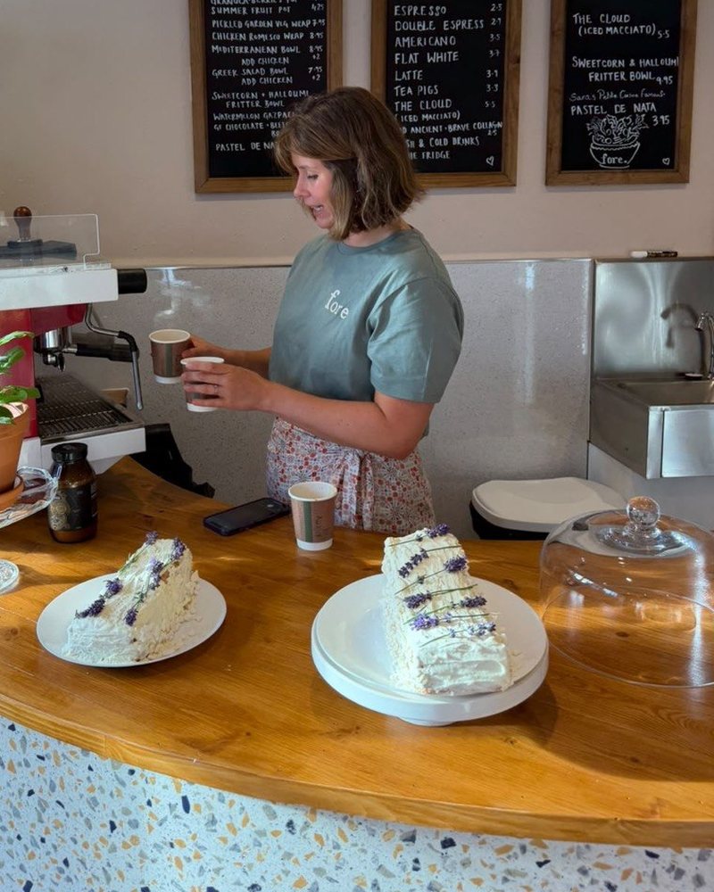 Claudia, founder of fore., making coffee behind the counter